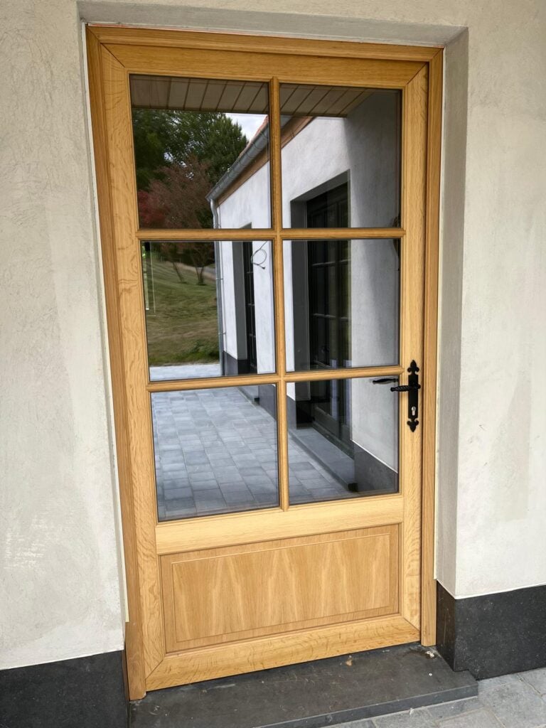 Porte d'entrée vitrée en bois ton chêne à six carreaux avec poignée en fer forgé noir